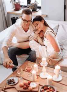 A romantic getaway, a couple enjoying wine and snacks by candle light. A gentlemen's guide for a memorable weekend