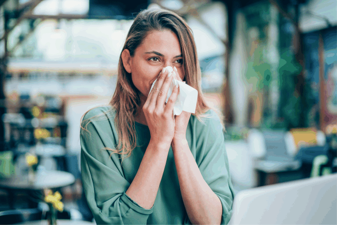 a women suffering from allergies, Benefits of natural cleaning for allergy sufferers