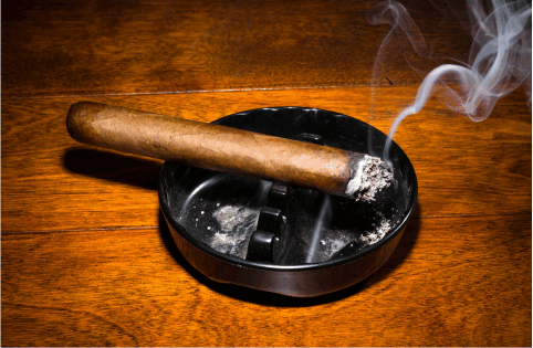a cigar in the ashtray, The Smoke Odor Solution BAT’Z to the Rescue