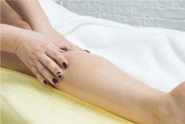 A women rubbing essential oils into her leg