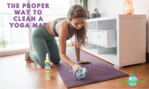 a women washing her yoga mat with a microfiber cloth and EarthSential Yoga mat cleaner