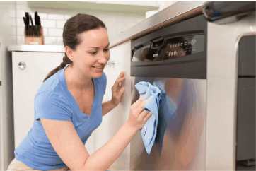 a women wiping her dishwasher with a micro fiber cloth, clean cans and can openers