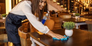 Someone cleaning a table in a restaurant, Why Food Safe Cleaners Matter in Restaurants