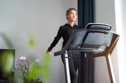 a women working out on a treadmill, How to Clean Your Fitness Equipment
