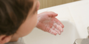 a kid washing hands