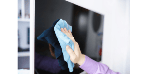 a tv screen being cleaned
