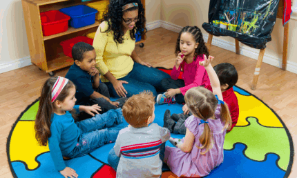 preschoolers sitting on the rug at school. a preschool provider's guide to safe cleaning