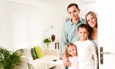 a family at the front door, welcoming the guests. social acceptance and cleanliness