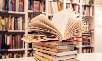 a stack of books. the path to a pristine bookstore with natural cleaners