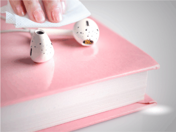 a pair of dirty ear buds. ear bud cleaning 101